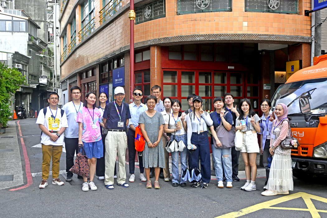 The walking-tour guide (forth from the left) with professors and students on a street in Dadaocheng.Image